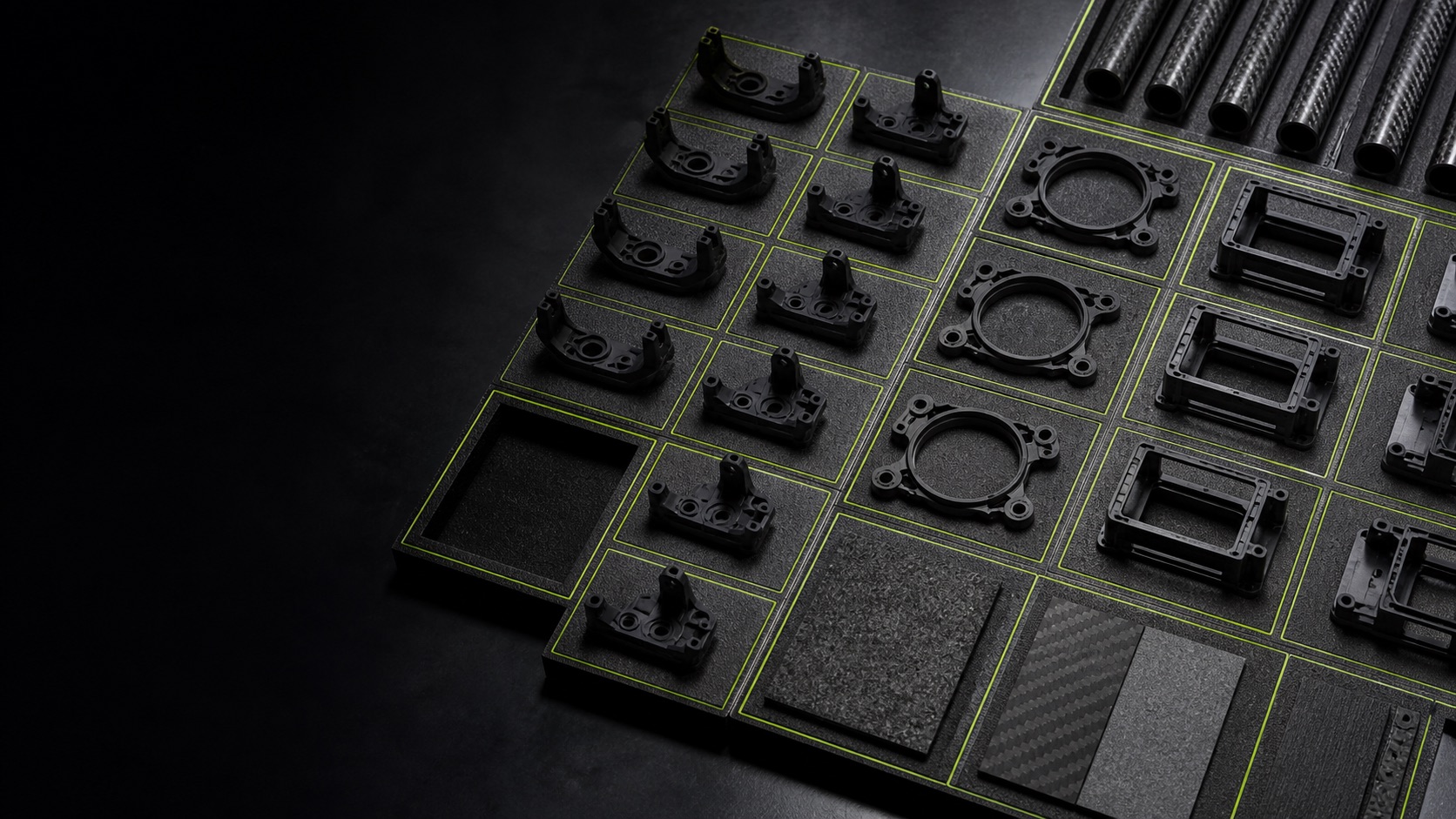 Separate polymer brackets, motor mount rings, open housings, composite tubes, and material coupons in marked inspection nests